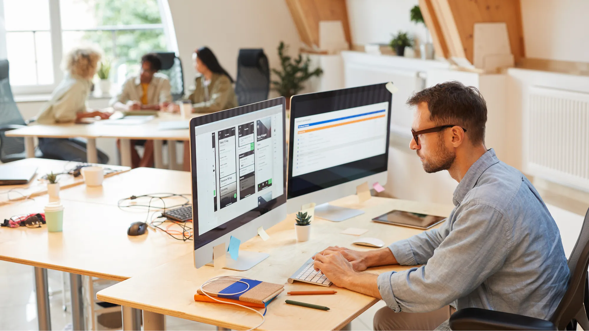 Developers writing code together in a modern tech workspace
