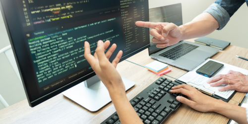 Illustration of software developers building a custom application interface, representing custom software development process